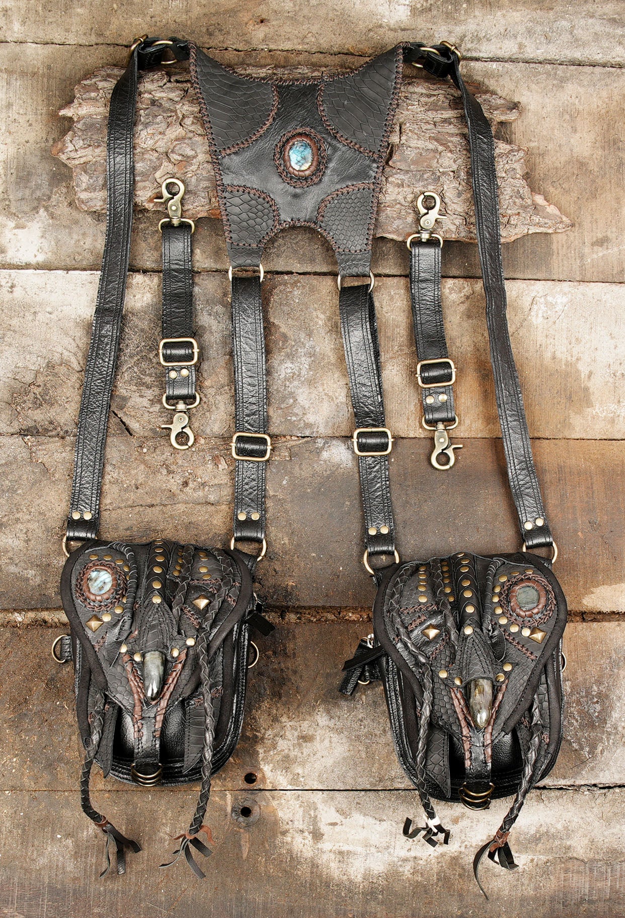 “Handmade black leather holster with snakeskin texture and gemstone accents”