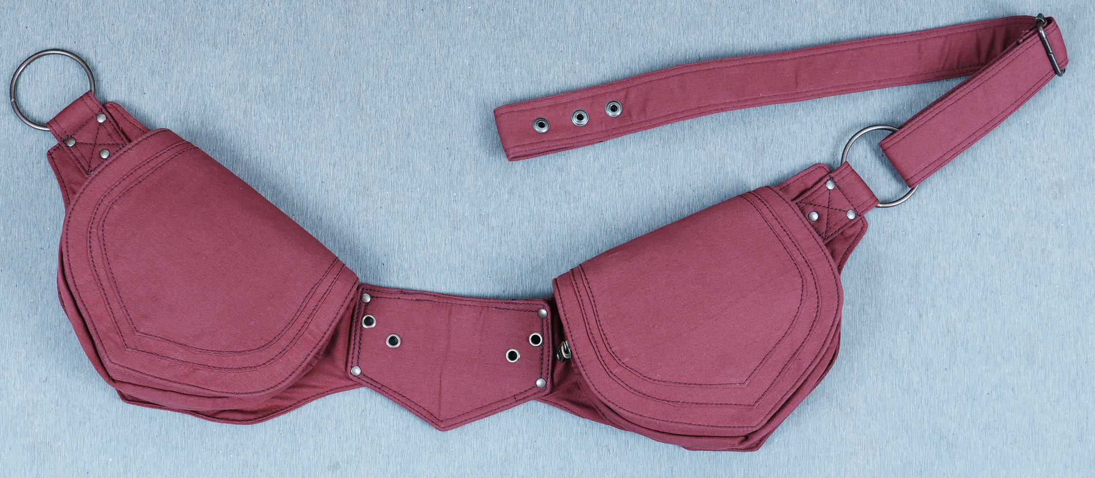 cotton fanny pack with two shield-shaped pouches, laid flat. Perfect travel accessory.