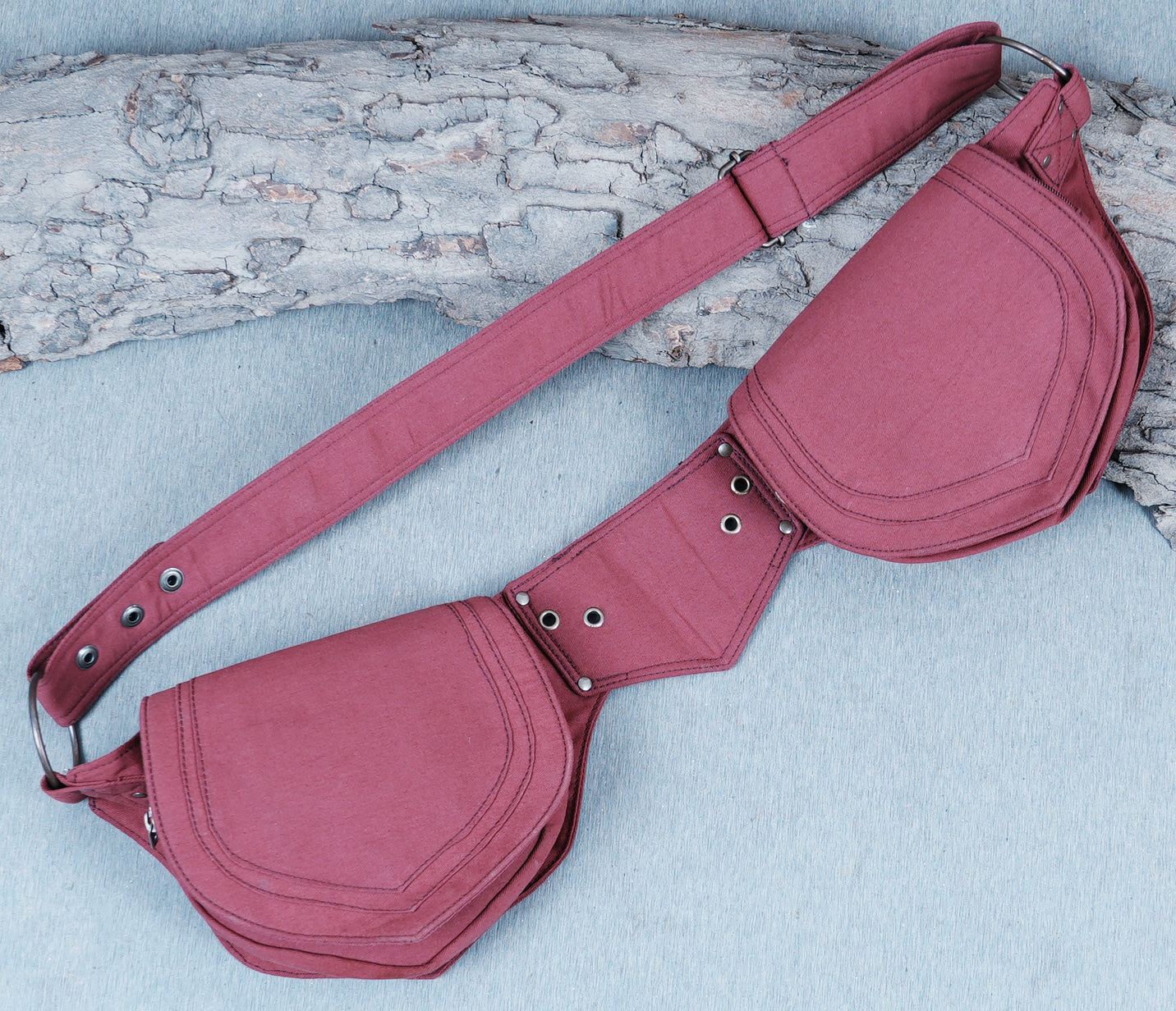 Canvas waist pouch with large metal D-rings and an adjustable grommeted belt.