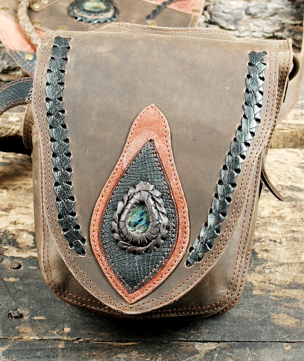 “Artisan leather shoulder holster featuring mixed-tone panels and gemstone centerpiece”