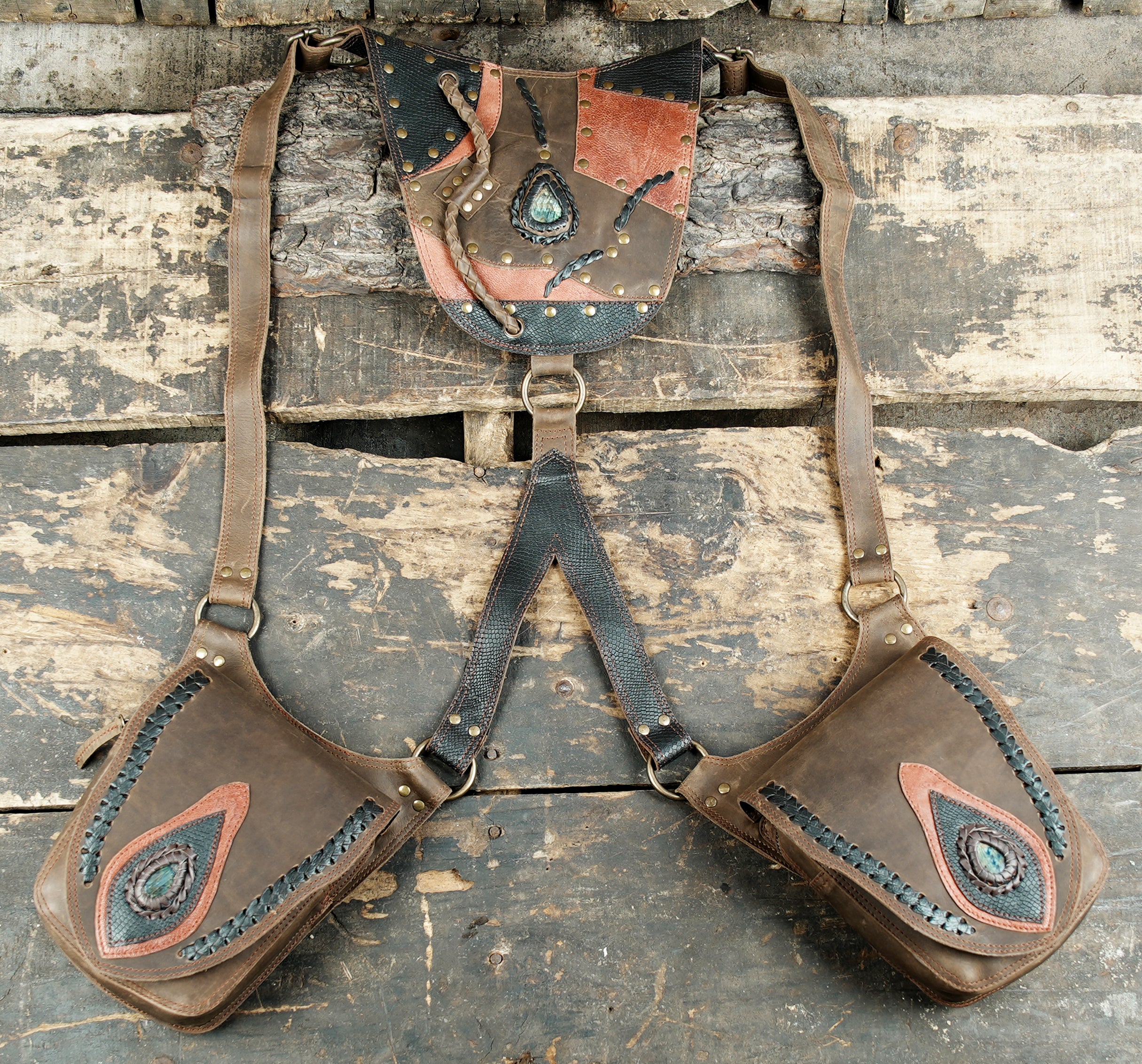 “Brown patchwork leather double holster with gemstone accents and braided stitching”