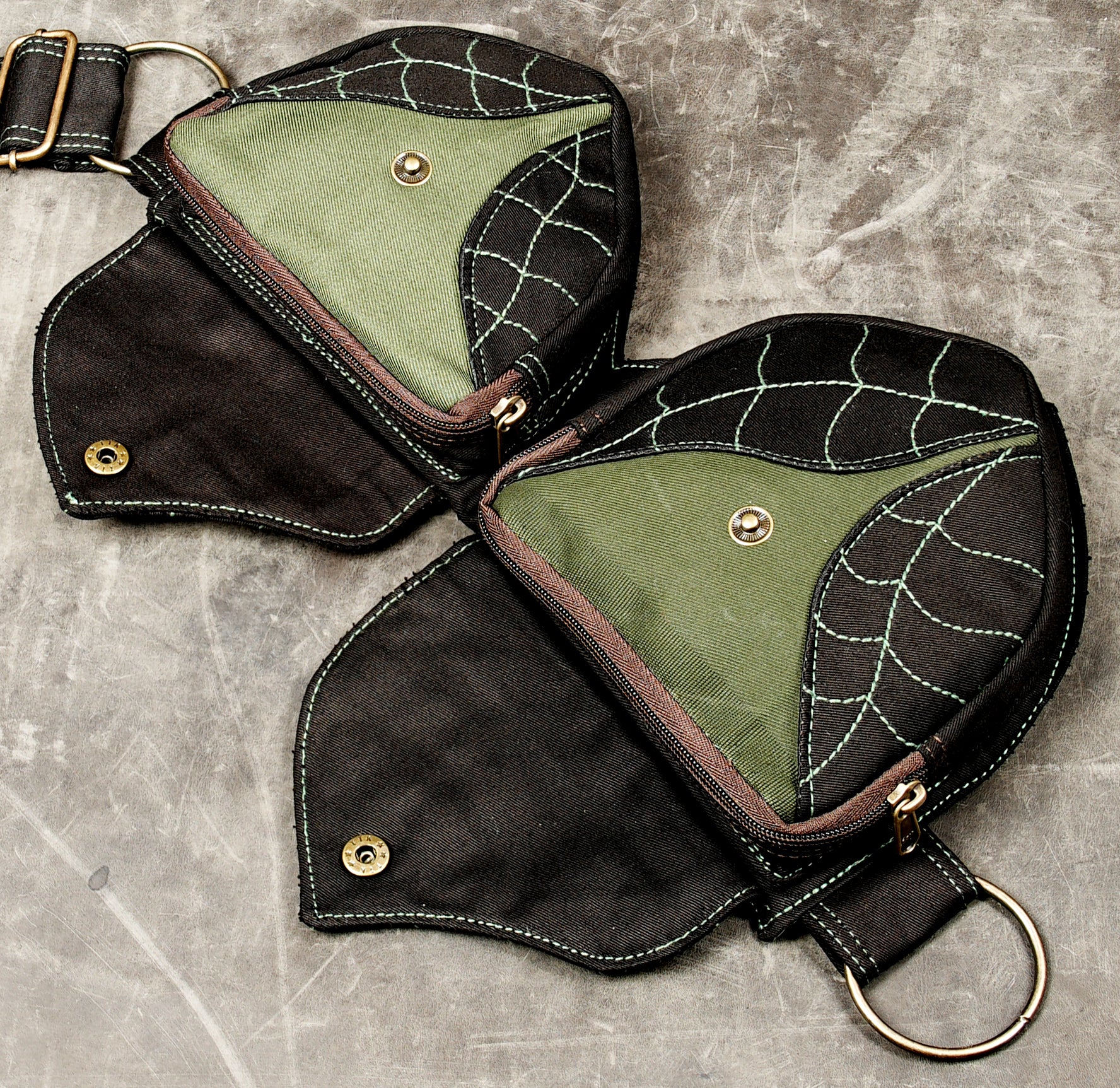 Hippie utility belt in black cotton with green web stitch design and brass zippers