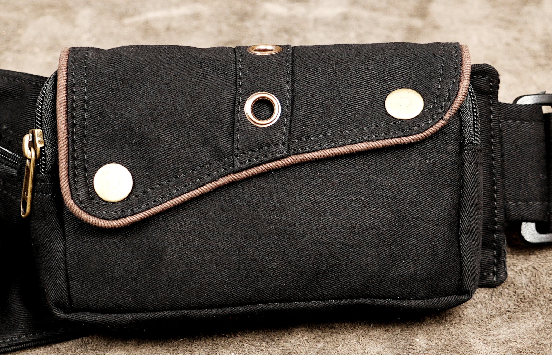 Black festival waist belt with zipper pockets and brass eyelets