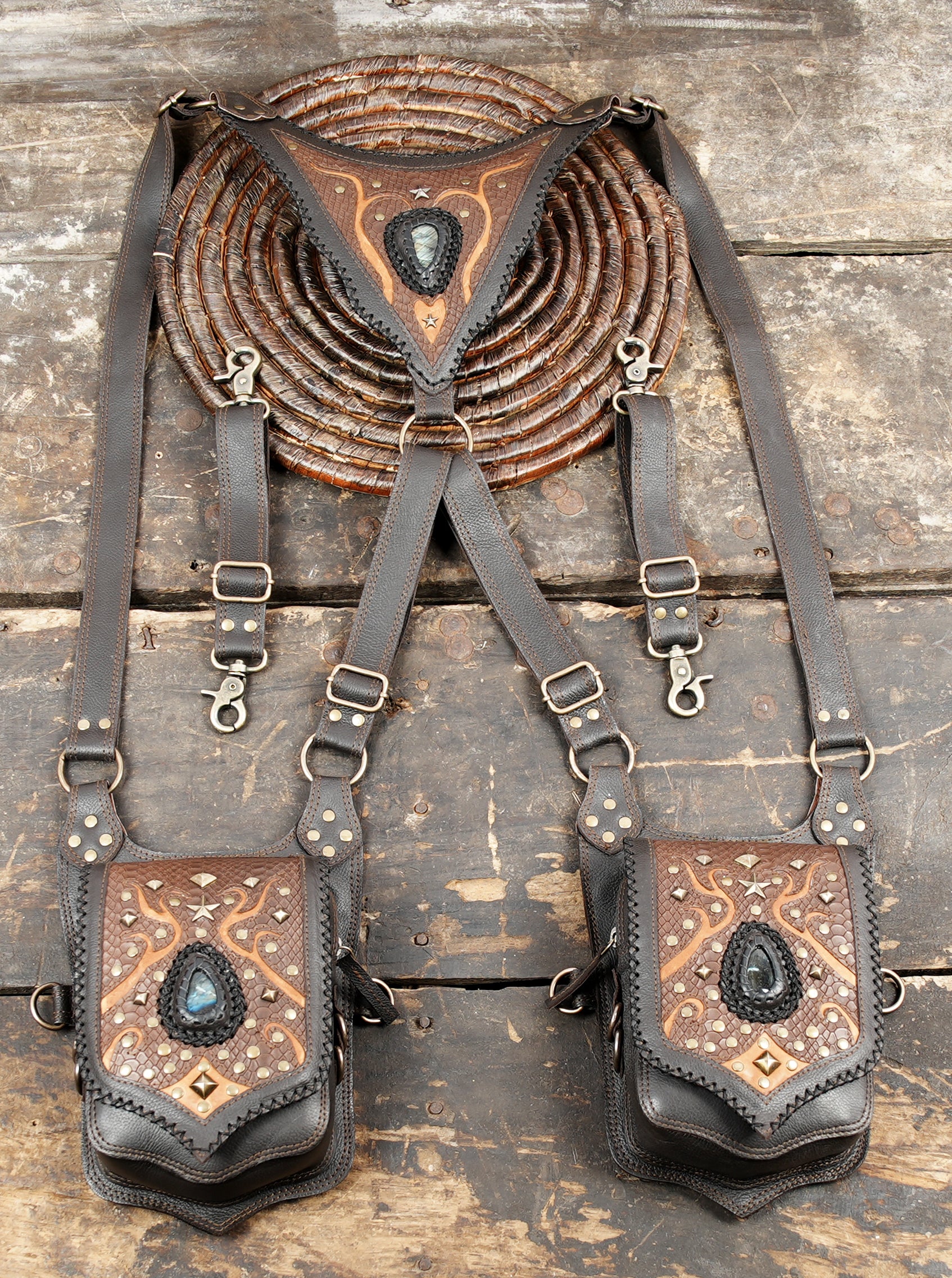 “Black dual pouch holster featuring copper patterns and tribal gemstone art”