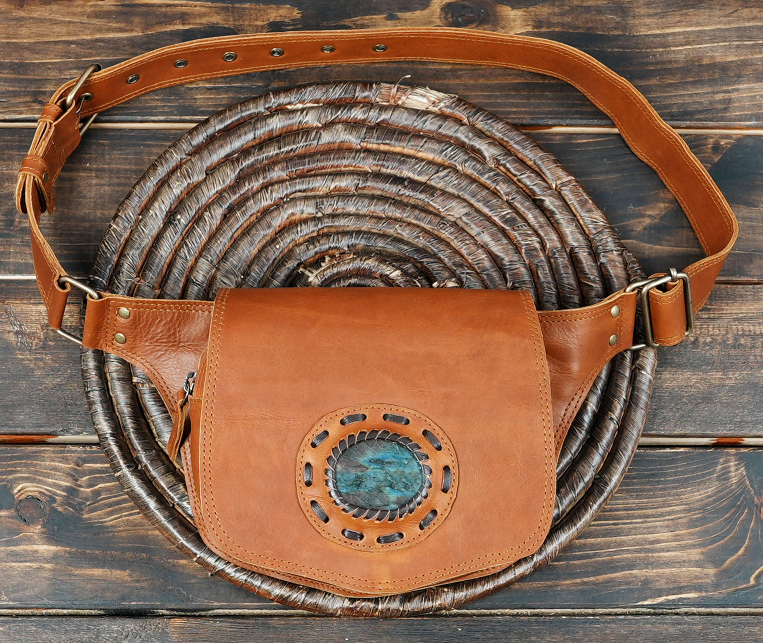 Elegant black leather waist purse featuring a polished stone