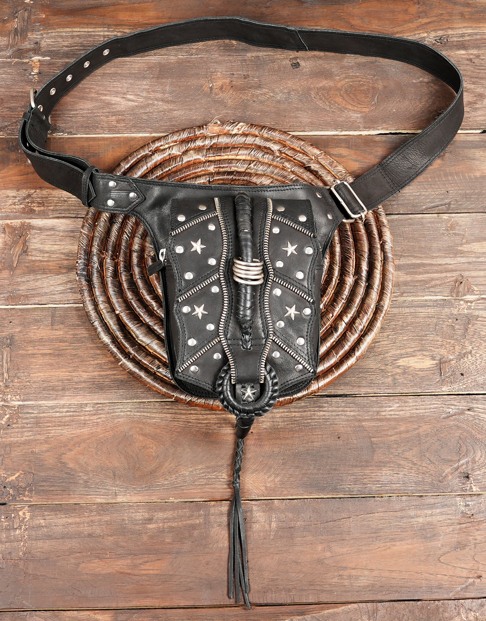 Handmade black leather thigh bag with star studs and tassel