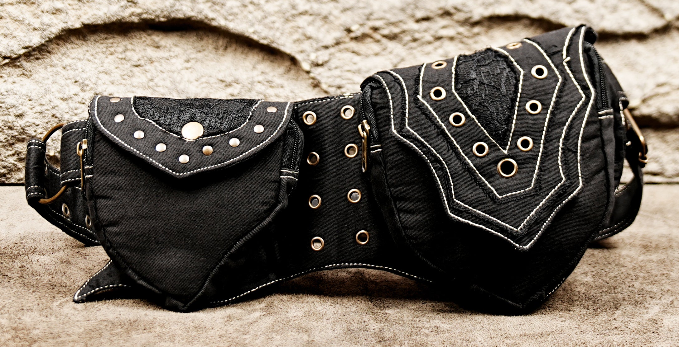 Black festival waist belt with twin zip pockets and white stitching