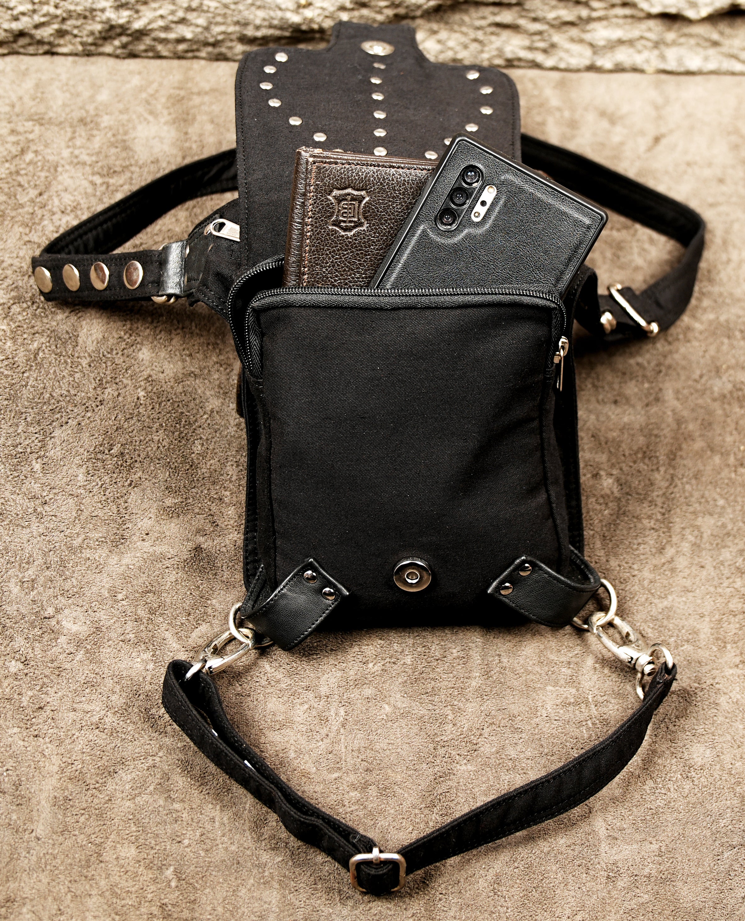 Functional and stylish black cotton canvas drop leg bag for concerts and outdoor events.