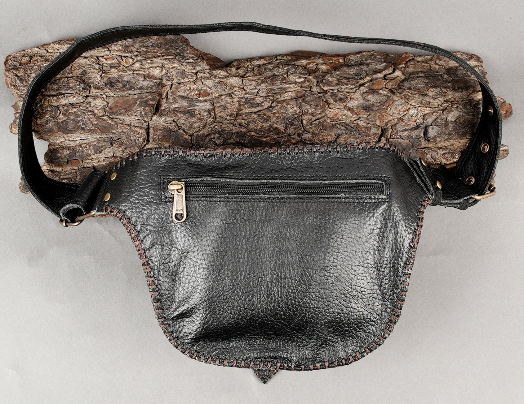 Handmade leather hip pouch with pointed flap and stitched design