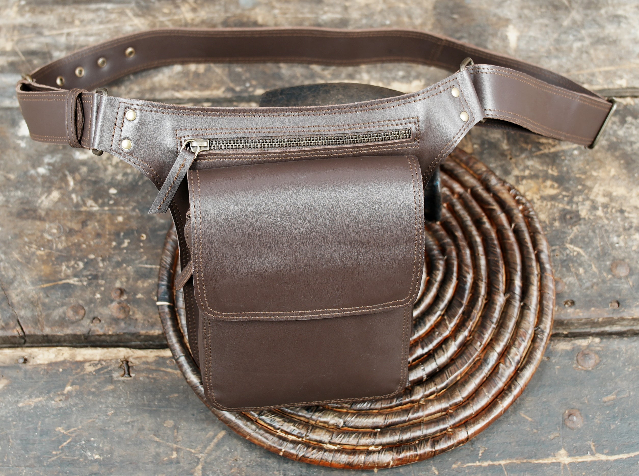 Durable leather travel belt bag with flap closure