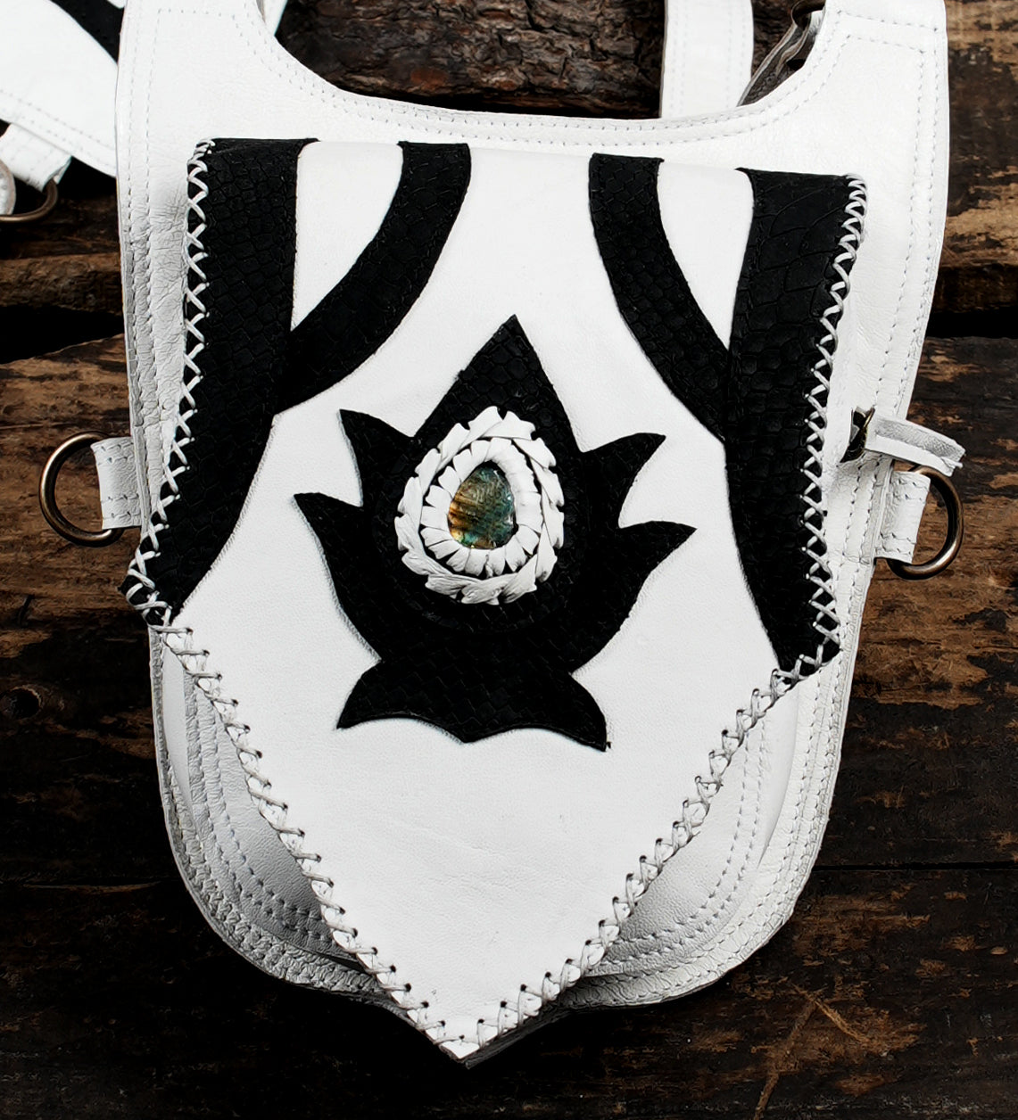 “Unique white and black leather holster with artistic cutout design”
