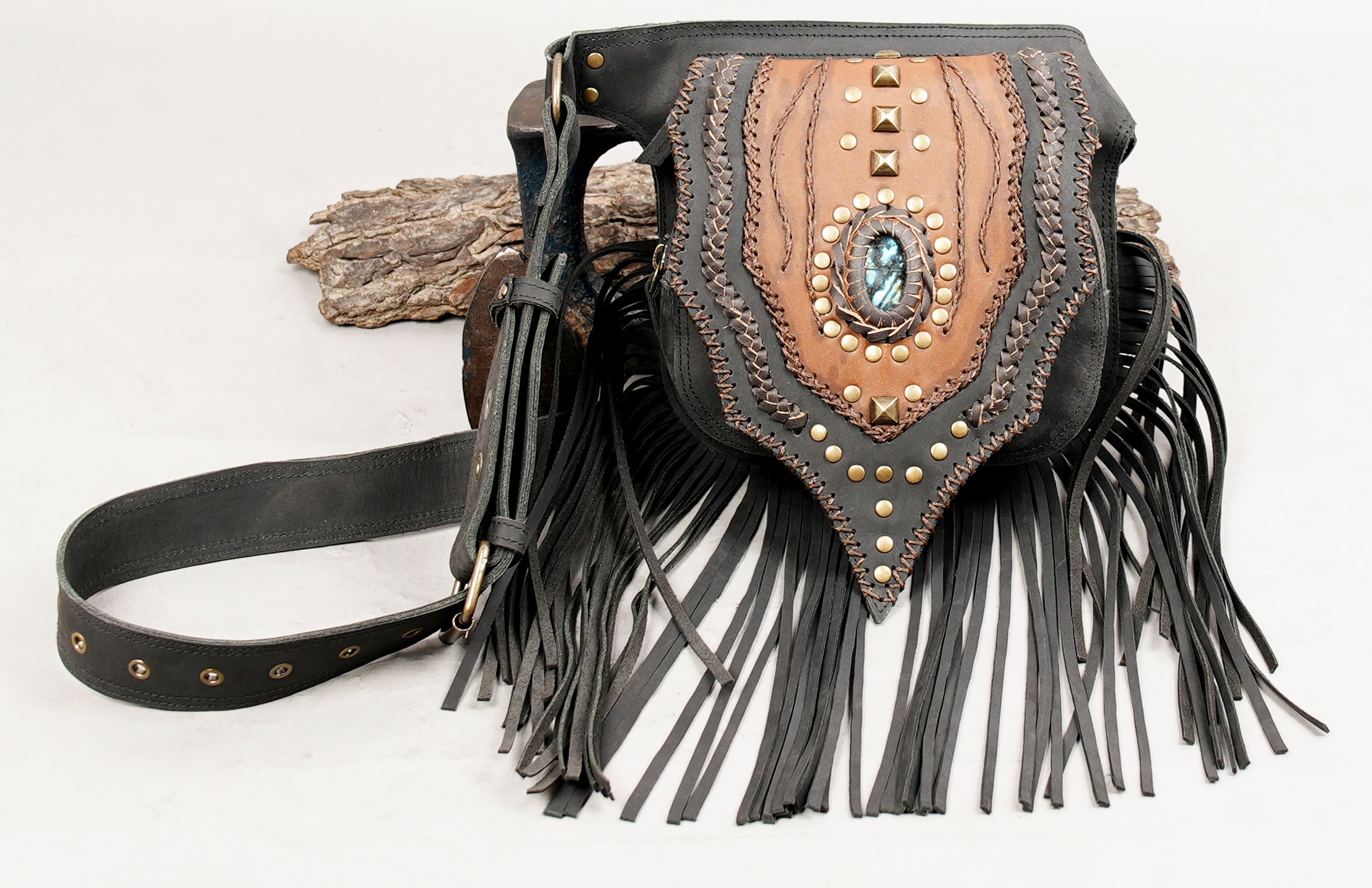 Tribal leather hip bag featuring gemstone artwork and metal studs.