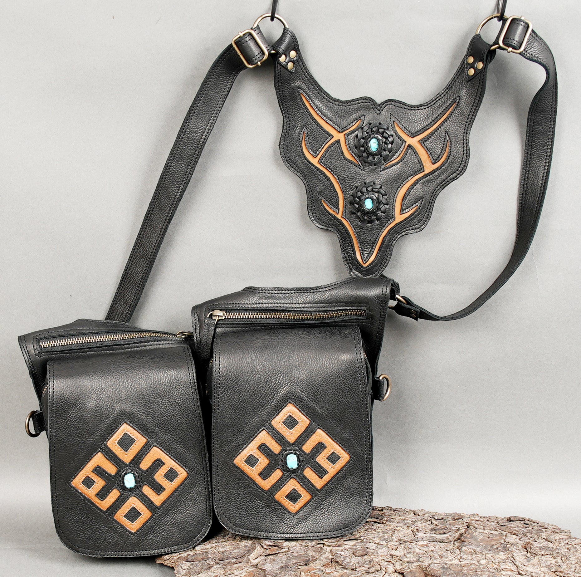 Stylish black leather holster with two front pouches and D-ring attachments.