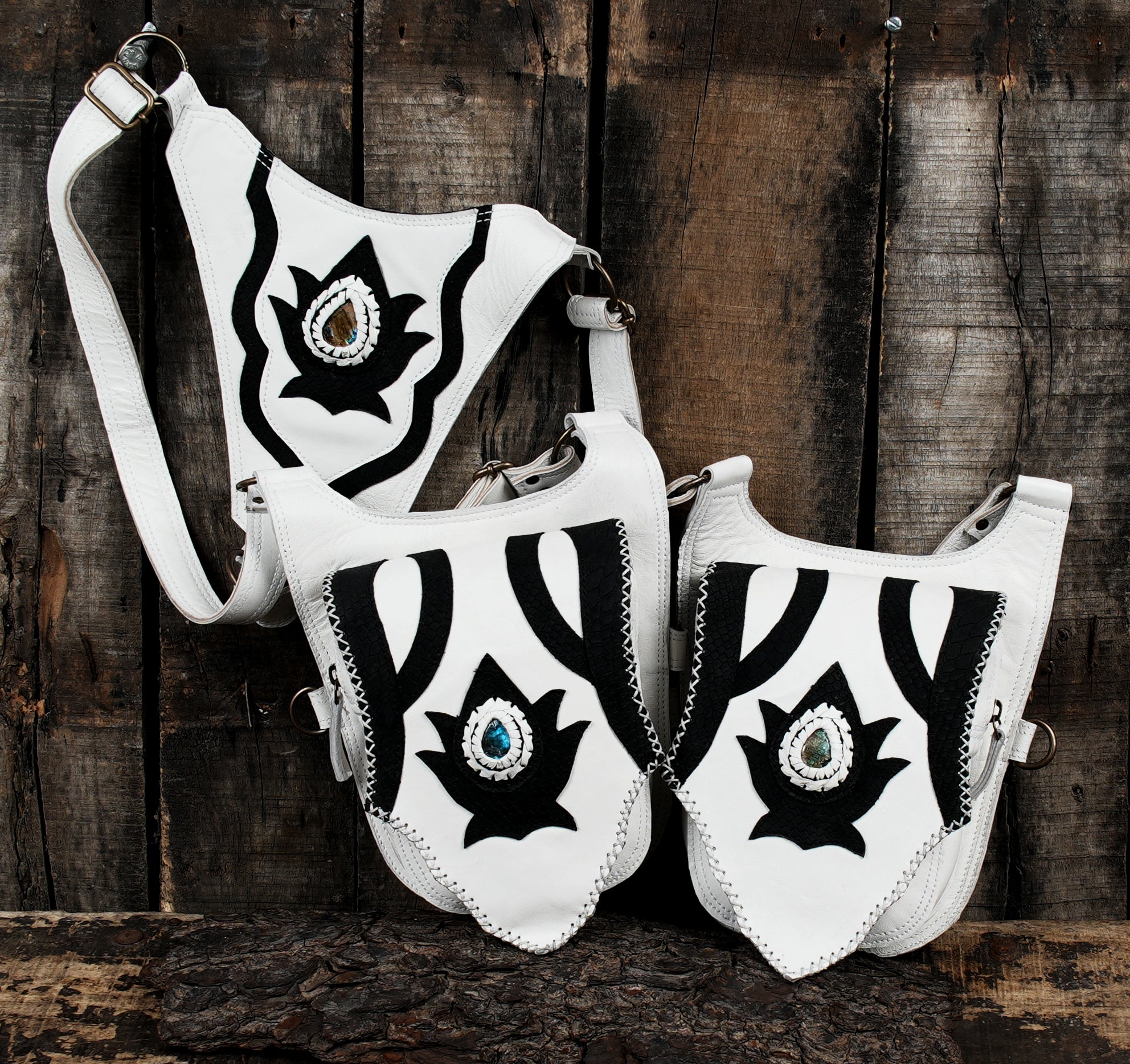 “White leather crossbody holster with gemstone front and brass hardware”