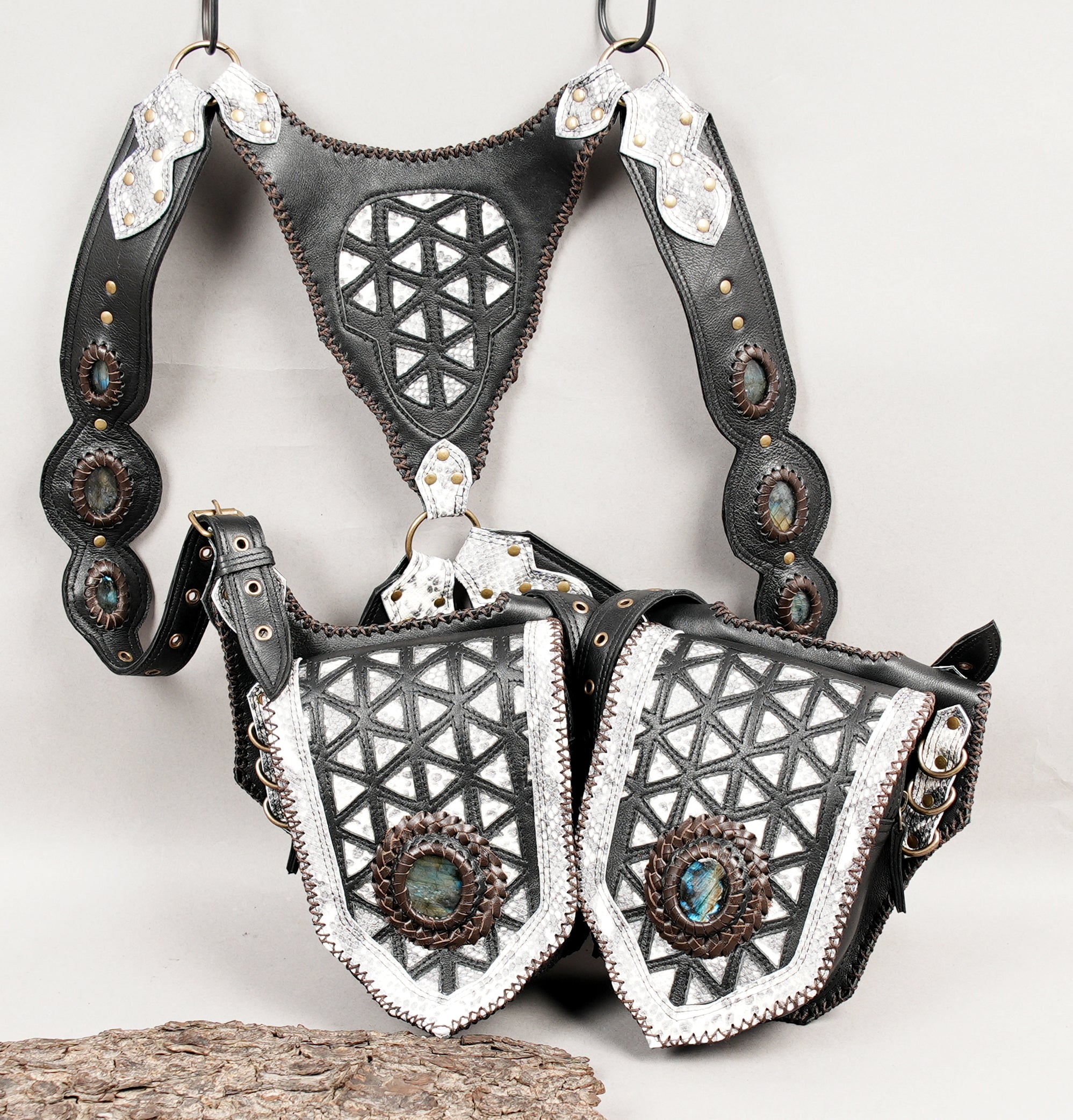 Artistic leather holster with braided stitching and gemstone center