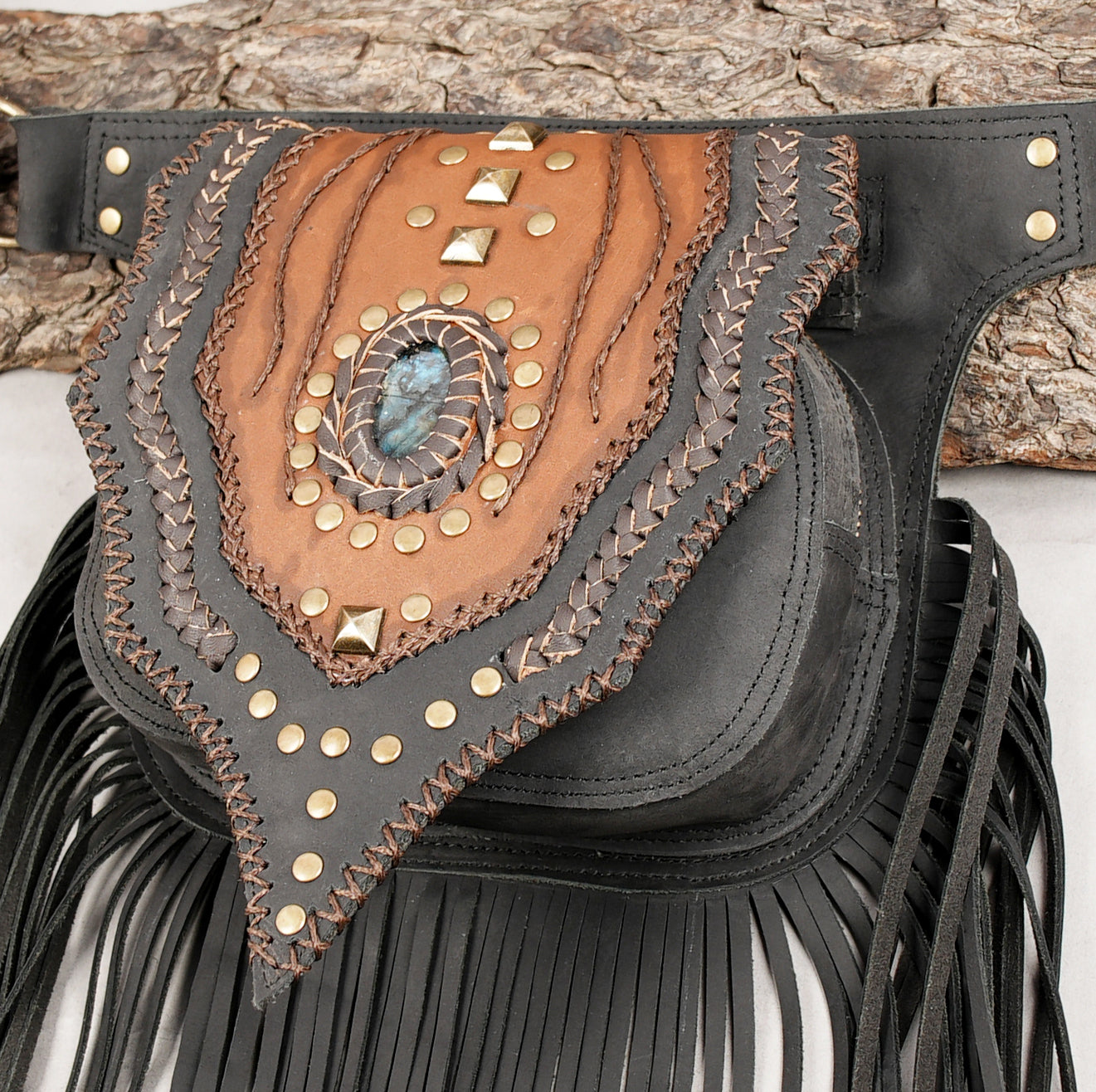 Black and brown leather belt bag with gemstone inlay and decorative studs.
