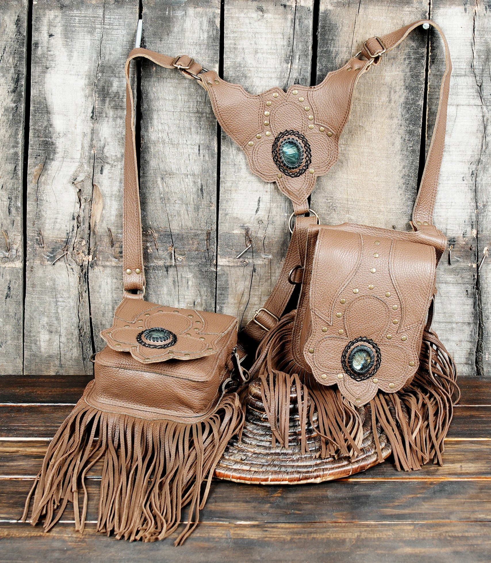 Leather harness bag with fringe trim and engraved floral pattern