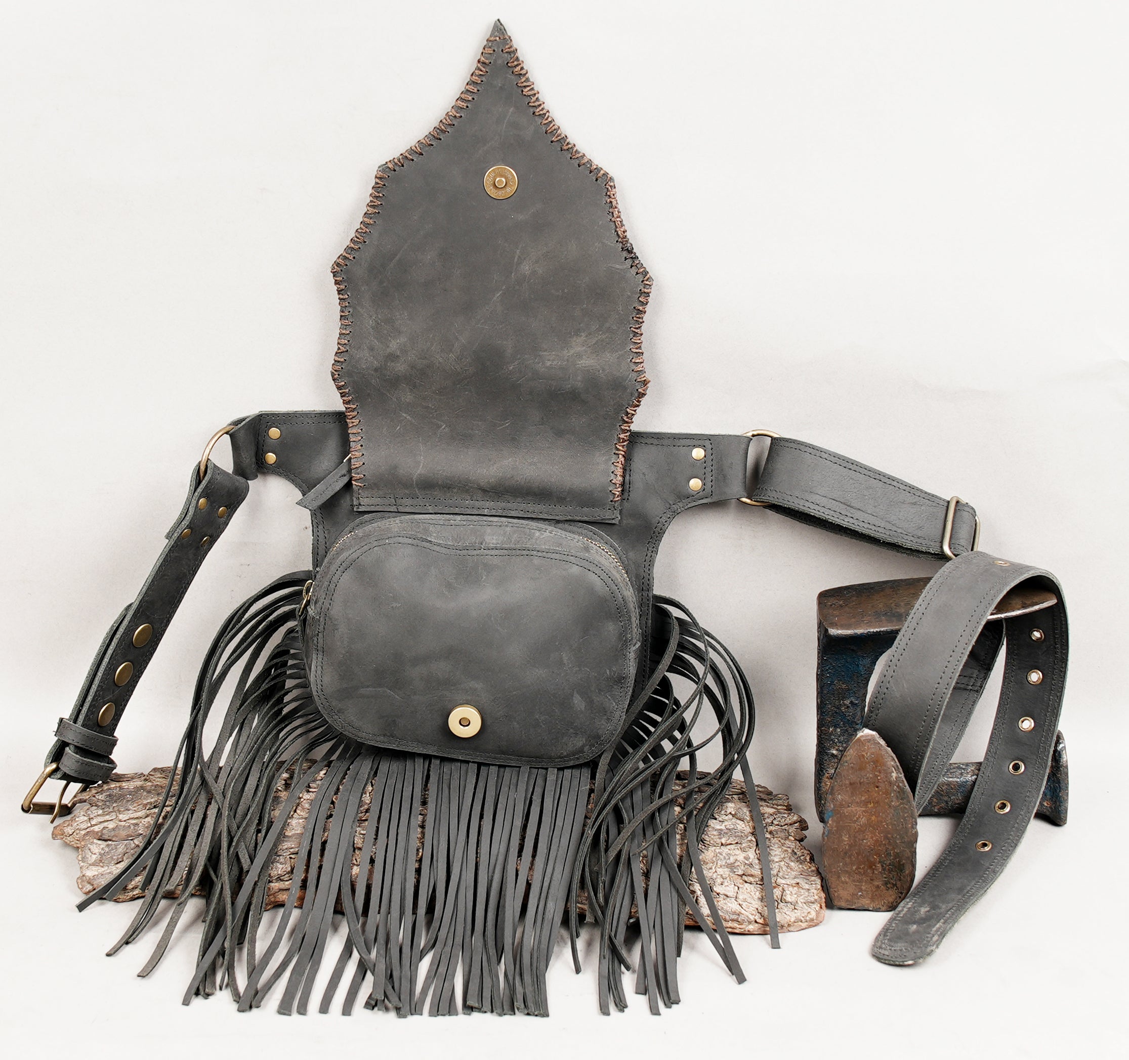 Bohemian leather belt pouch with long fringes and gemstone accent.
