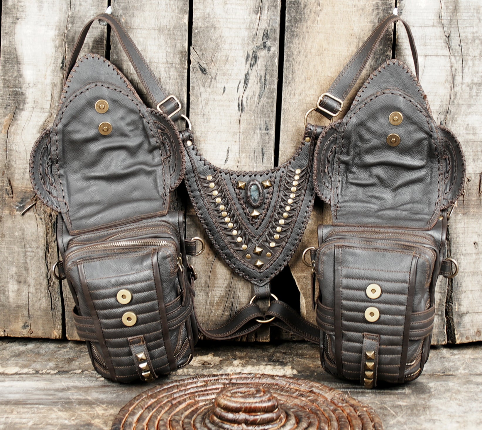 “Brown leather harness holster with gemstone embellishments and tribal textures”