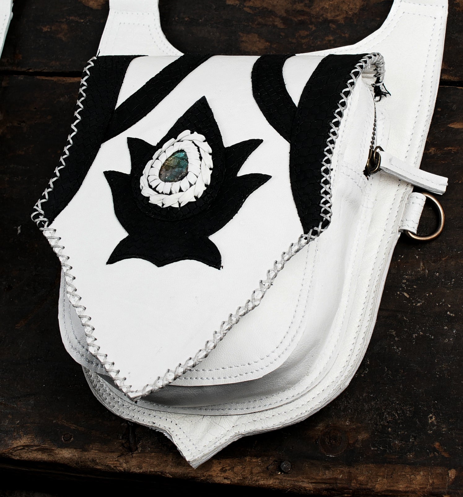 “Handcrafted white leather holster with tribal motif and gemstone detailing”
