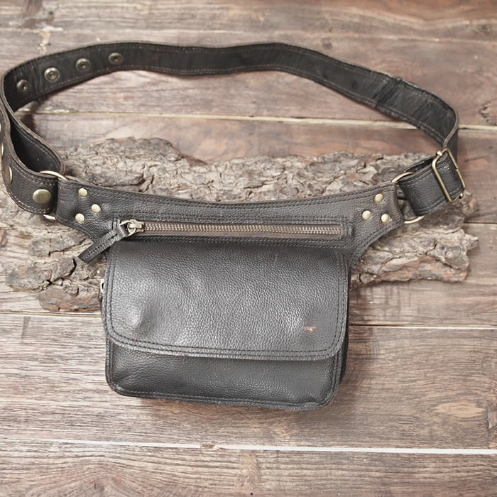 Close-up of black leather hip pouch with zipper