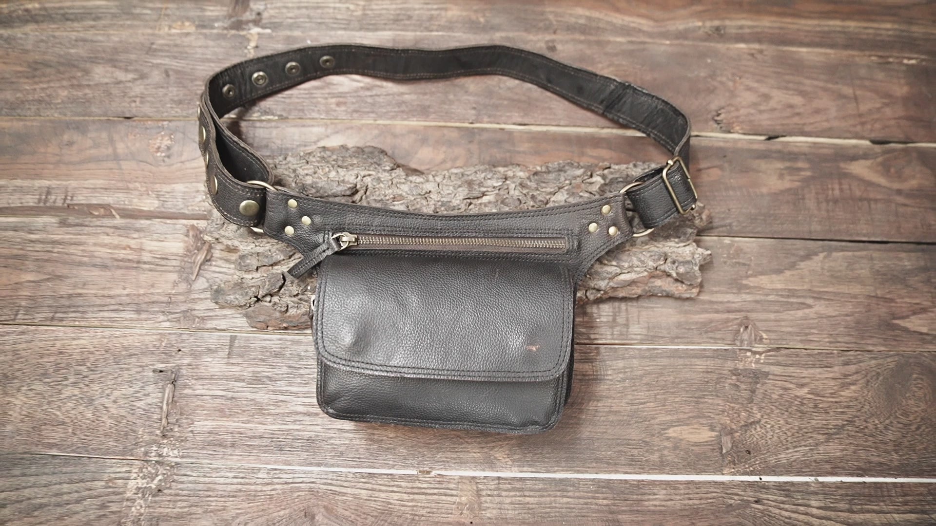 Close-up of black leather hip pouch with zipper