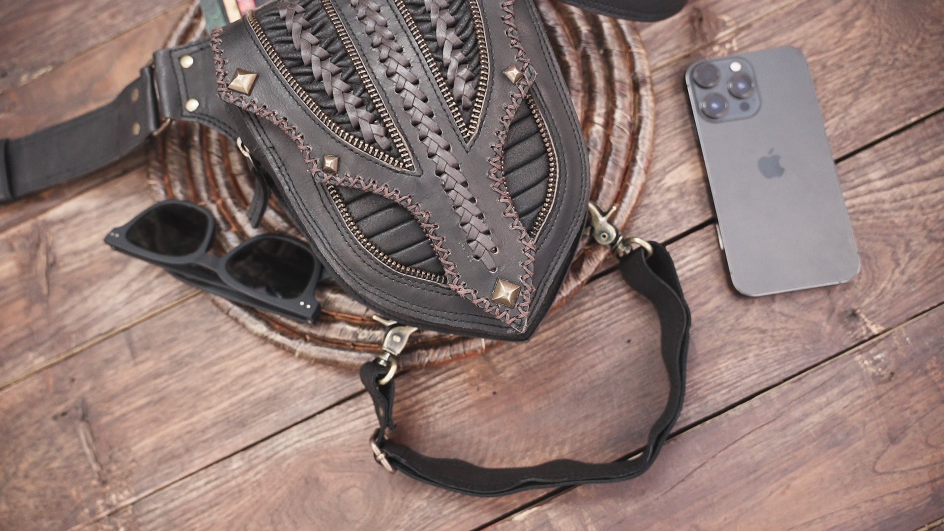 Artisan black leather thigh pouch with rustic festival design