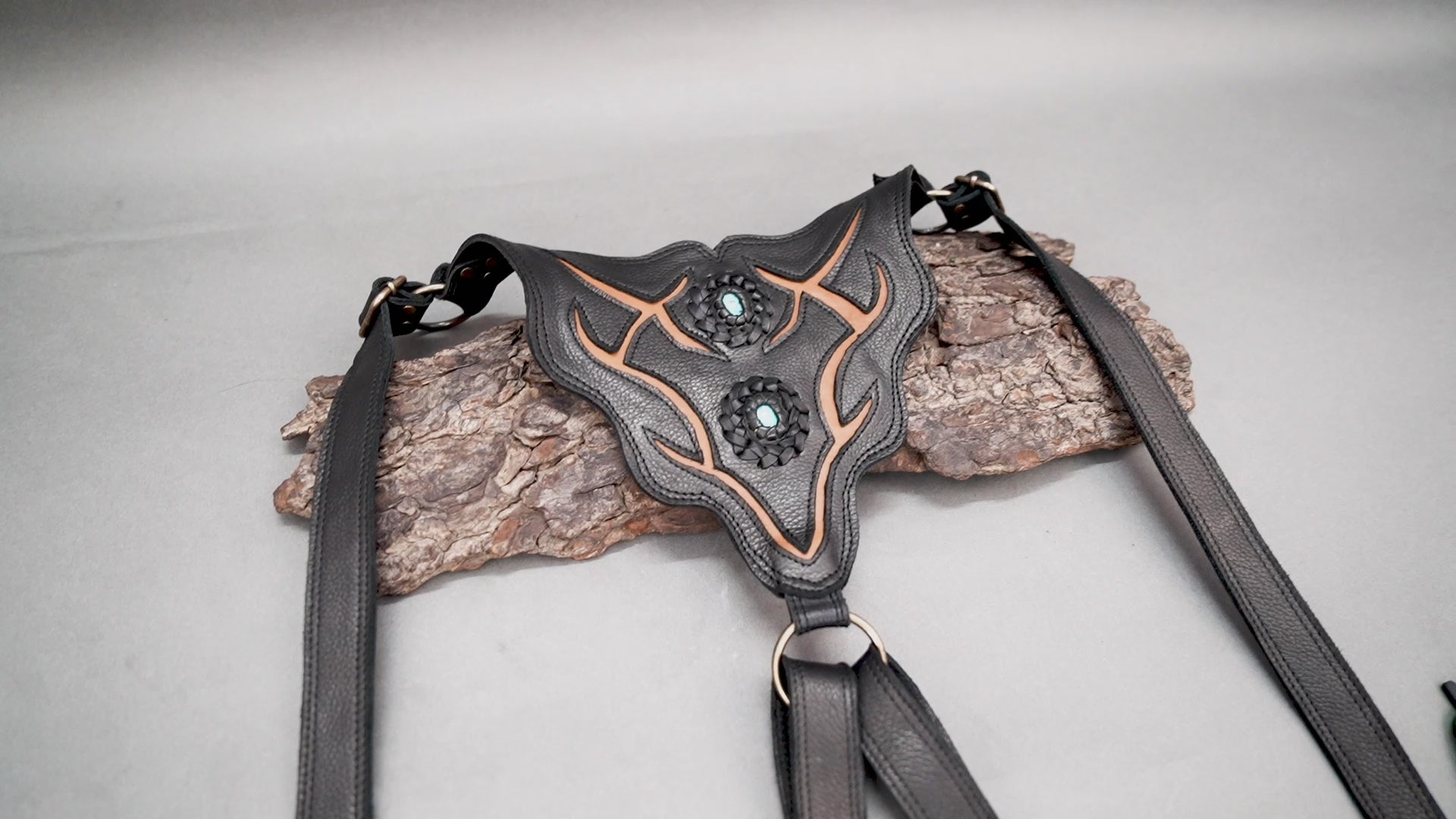 Handmade leather utility bag with tribal design and zipper pockets.