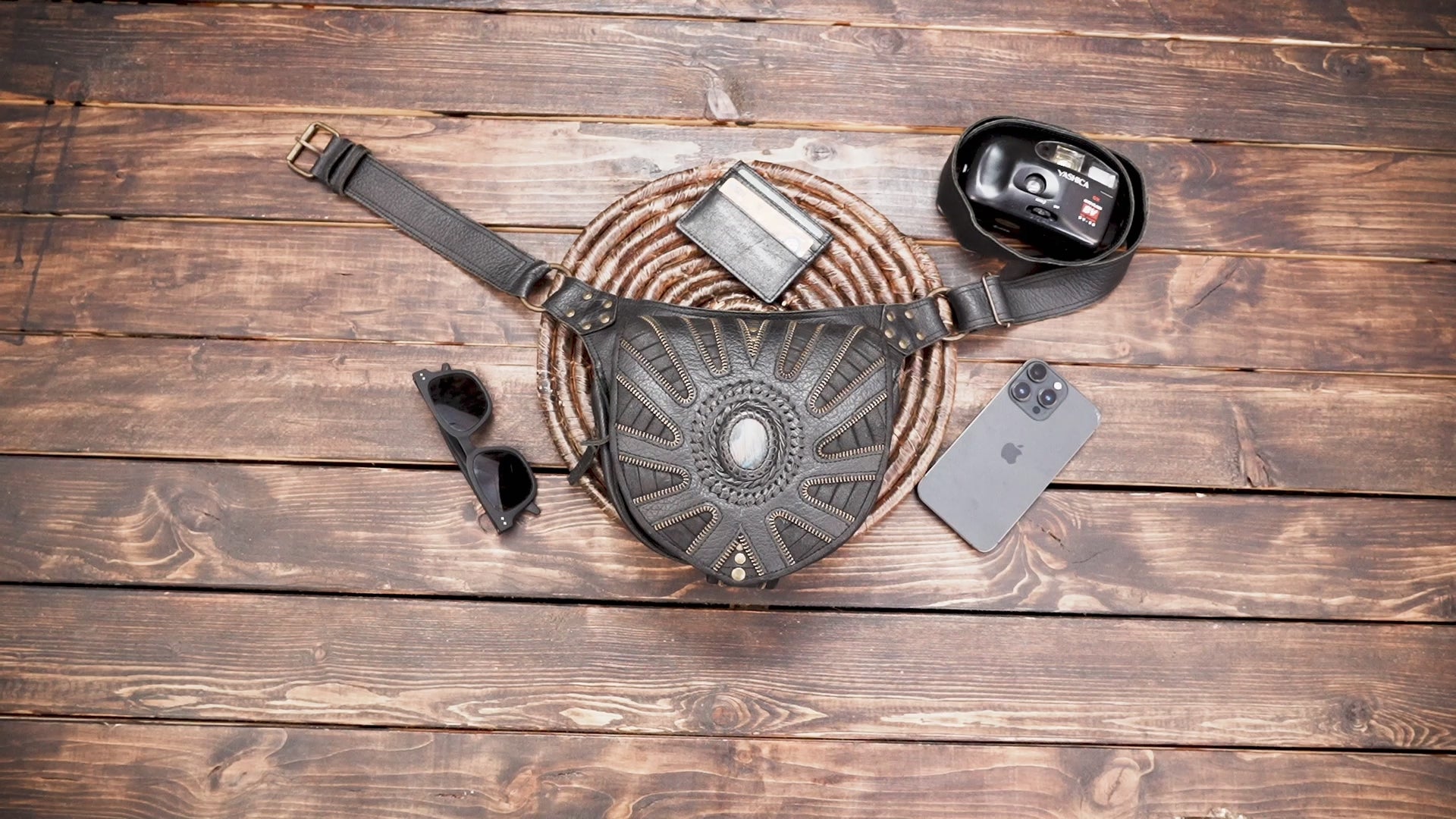 Western-style handcrafted leather waist bag with detailed stitching and stone inlay