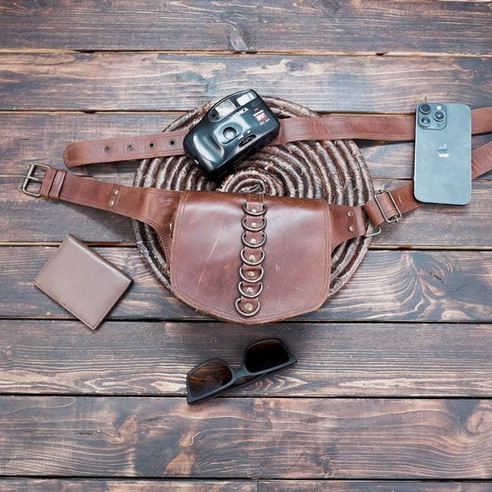 Artisan leather waist belt bag with decorative ring accents