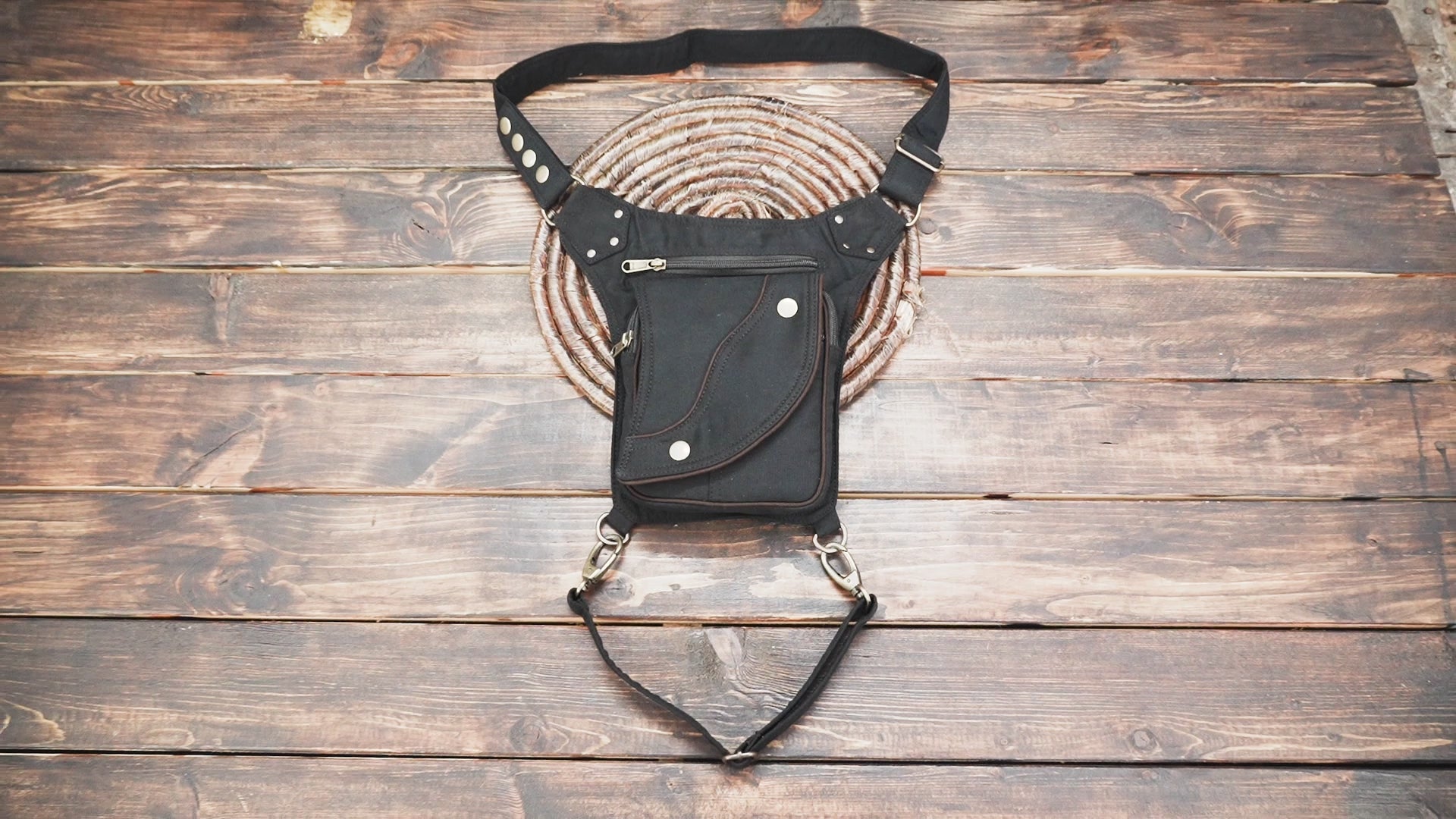 Multi-pocket black cotton waist pack festival bag with leg loop.