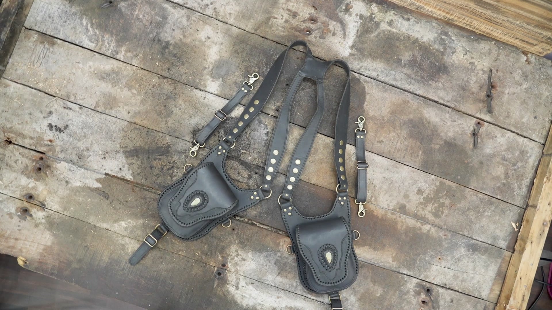 "Handcrafted leather shoulder holster with decorative stitching"