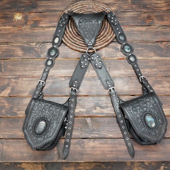 Artisan-made leather shoulder holster with detailed stitching and stone accent