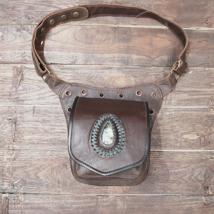 Close-up of gemstone detail on brown leather waist pouch