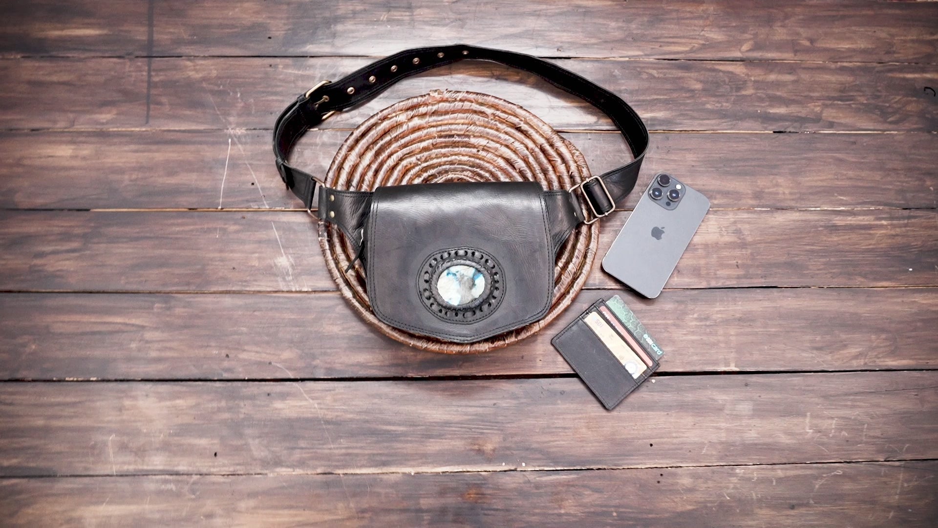 Black leather belt bag with decorative stone centerpiece