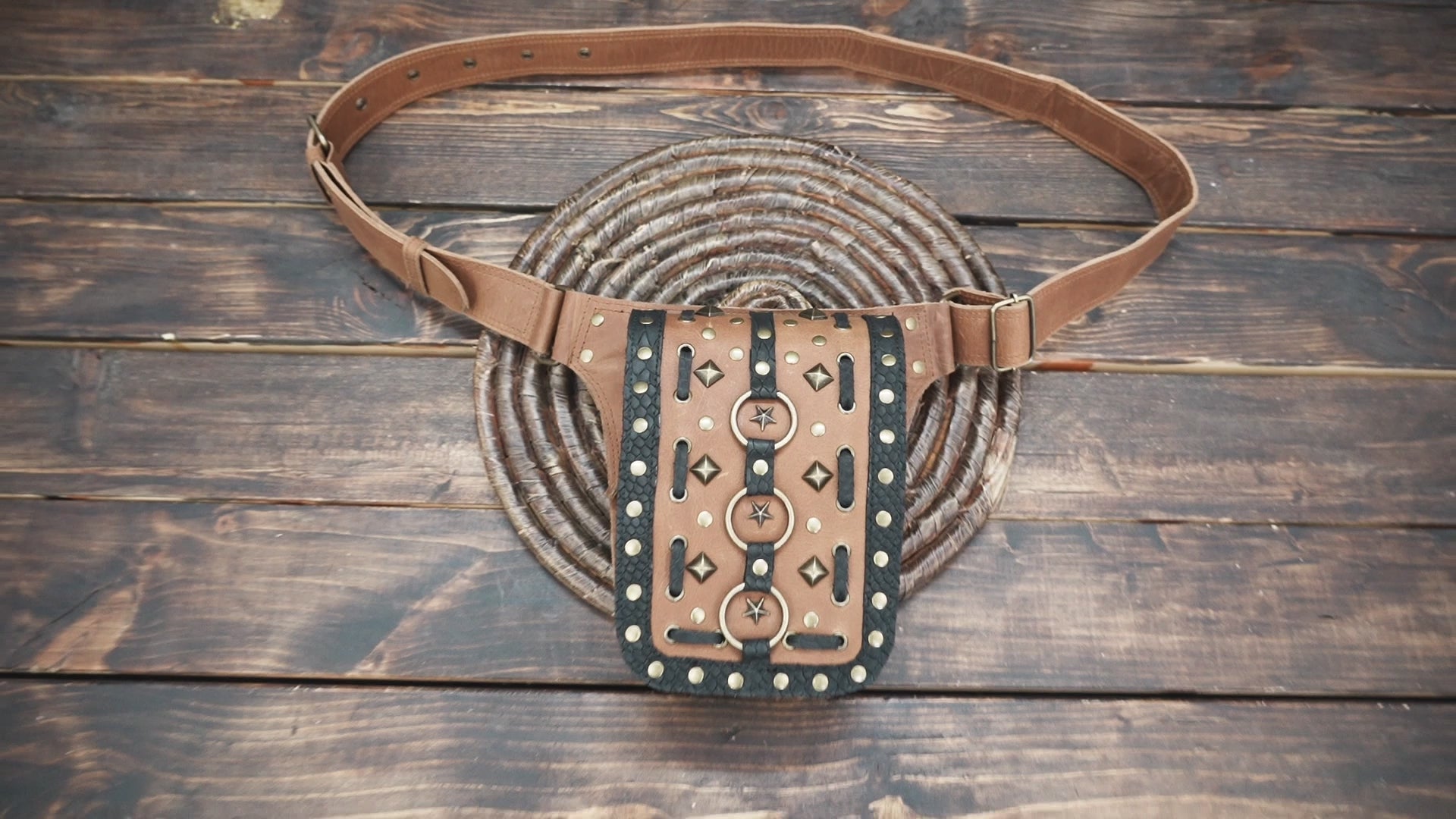 Premium brown leather belt with black detailing and brass rivets.