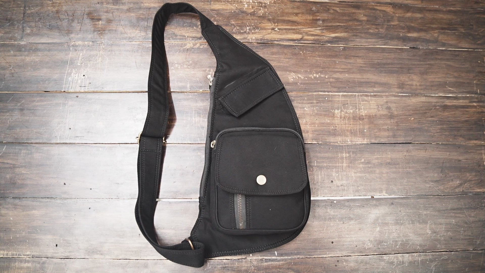 Gothic streetwear underarm sling purse with snap button pocket.