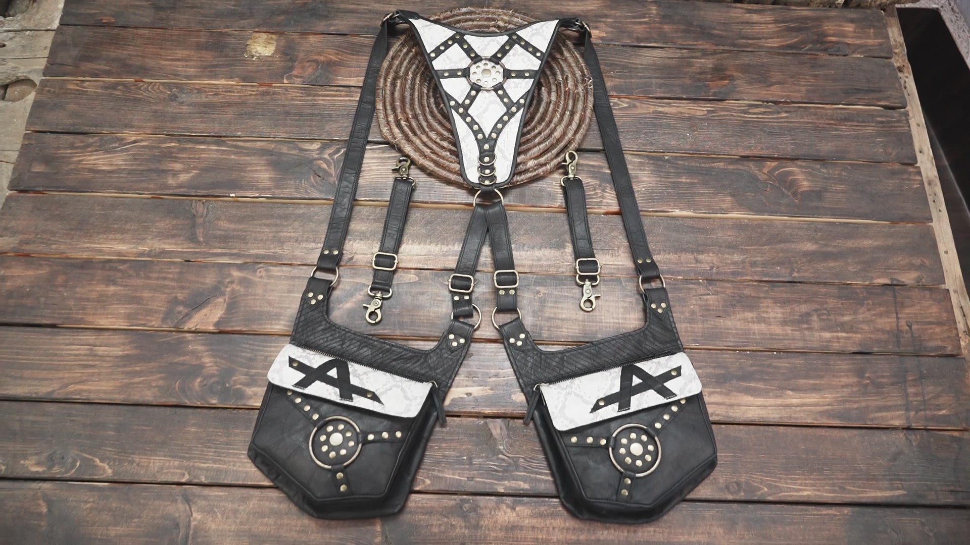 Dual-pocket black and white leather holster with vintage steampunk accents.