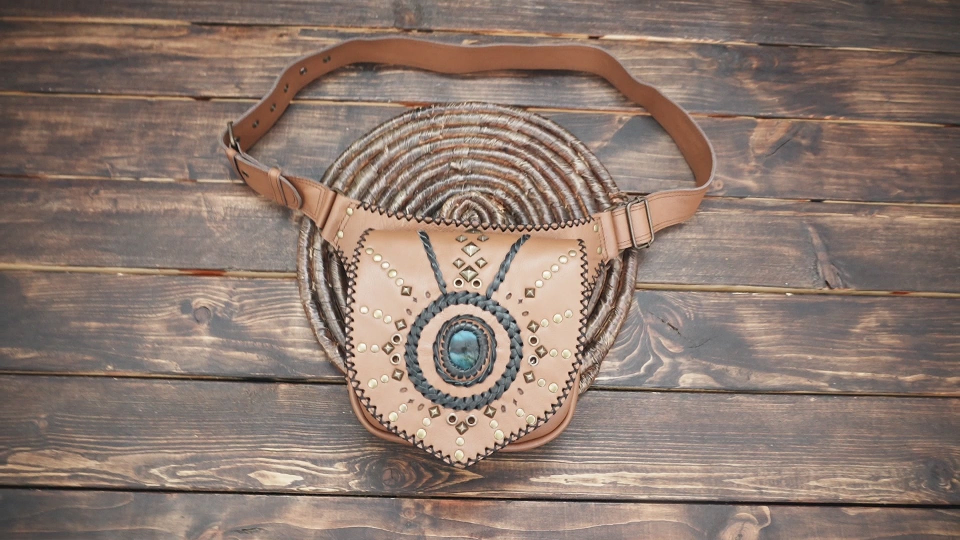 Handmade tan leather fanny pack with decorative studs and stone accent