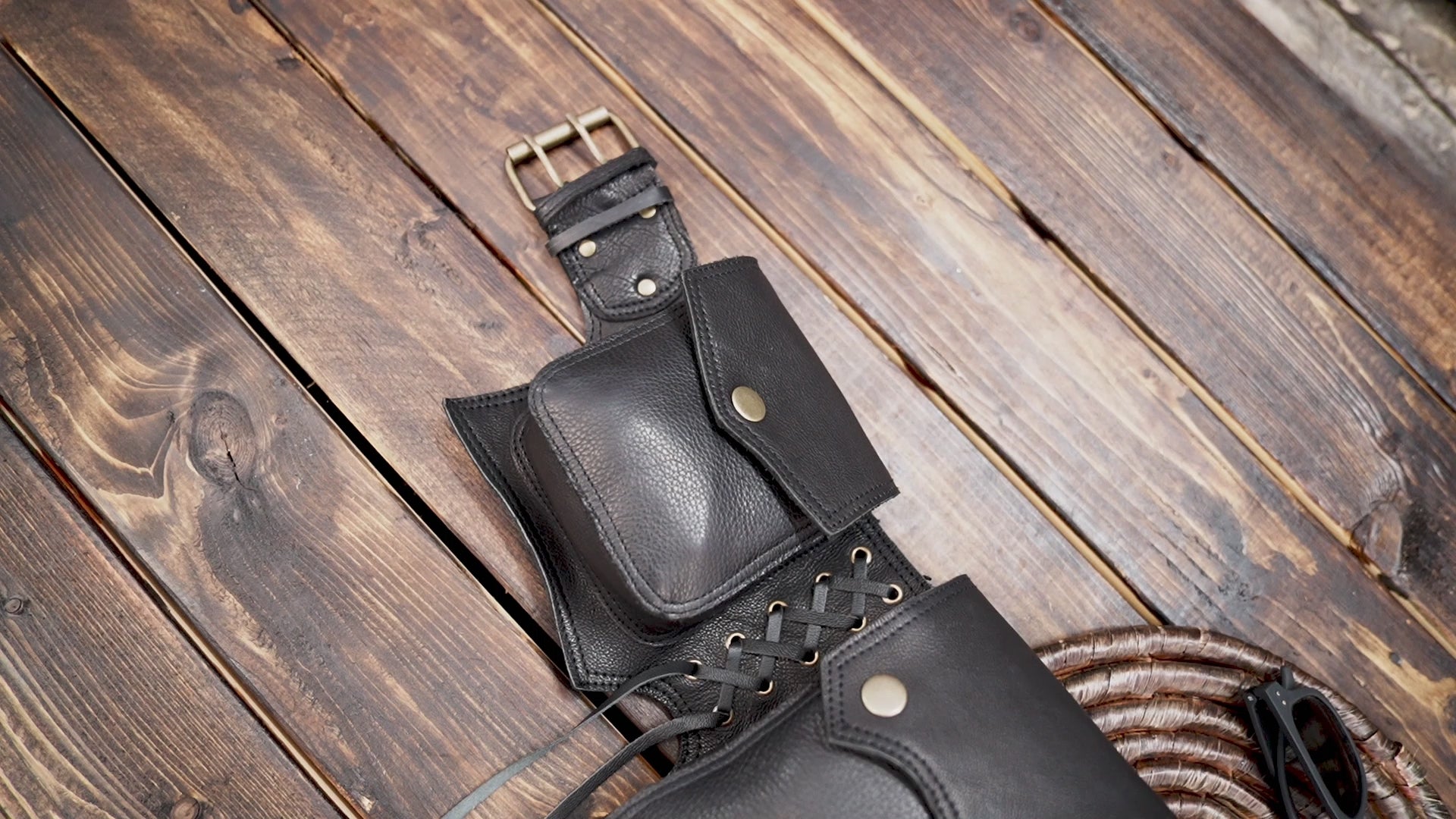 Western-style black leather hip pouch with dual pockets and rivet detailing