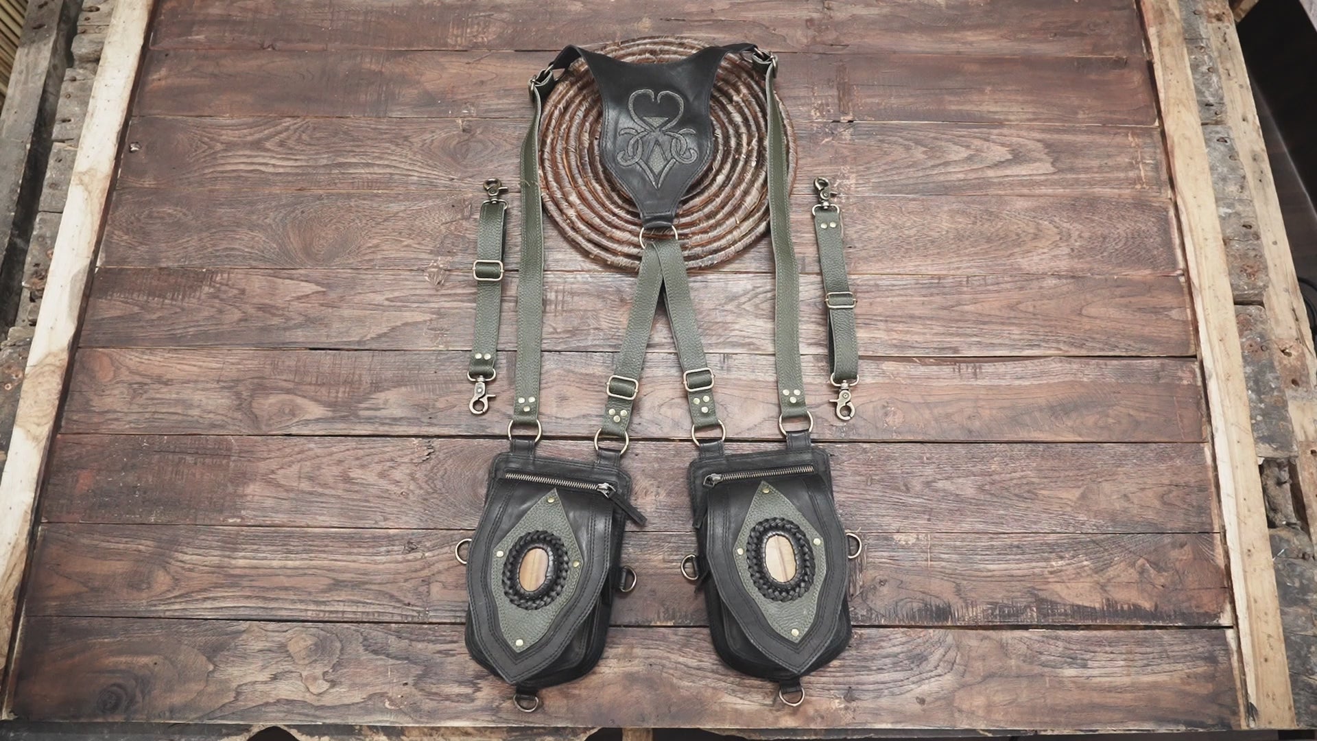 Handmade leather holster bag with green straps and oval stone detail