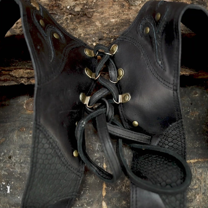 Handmade black leather holster bag with studded design and laced back