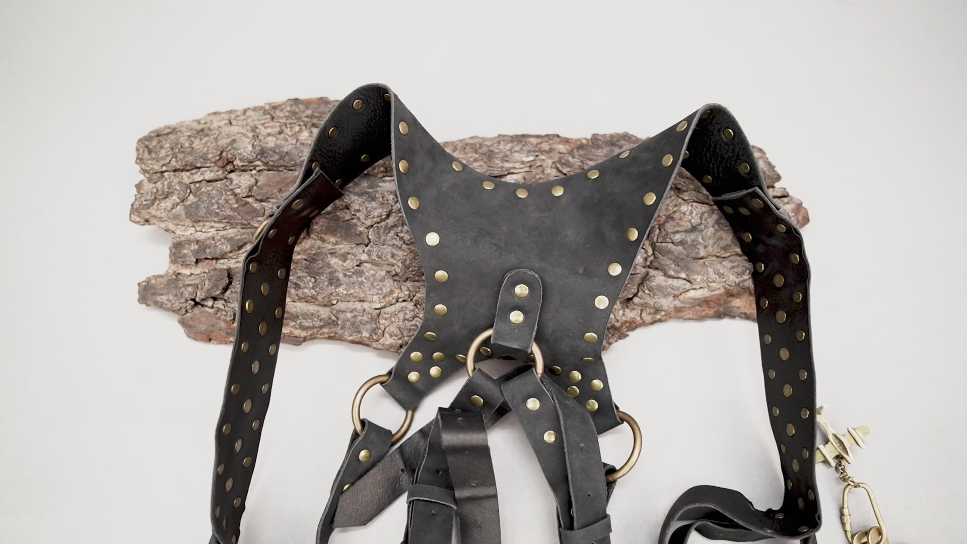 Black leather harness holster with tassel fringe detailing