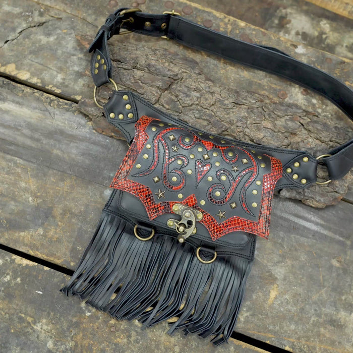 Western leather waist belt with studded design, red textured leather, and long fringe