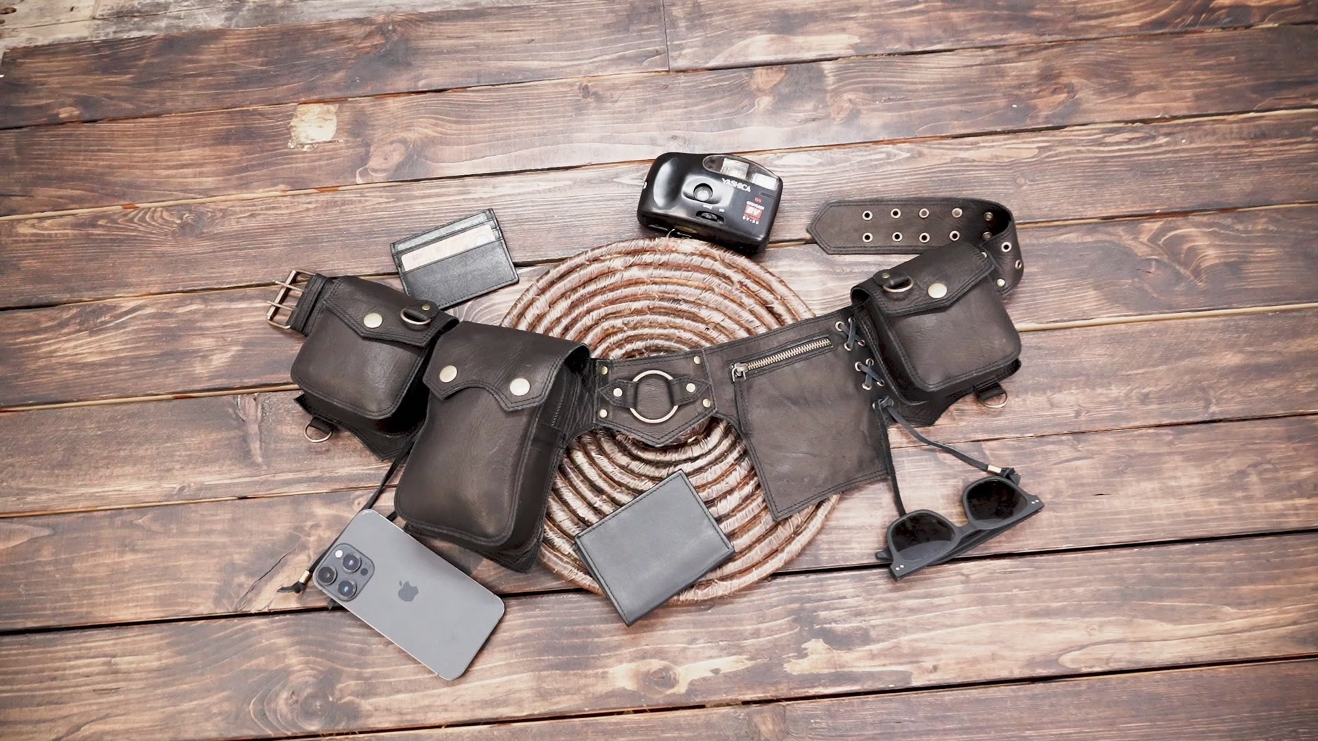 Black leather hip bag for men and women with brass details