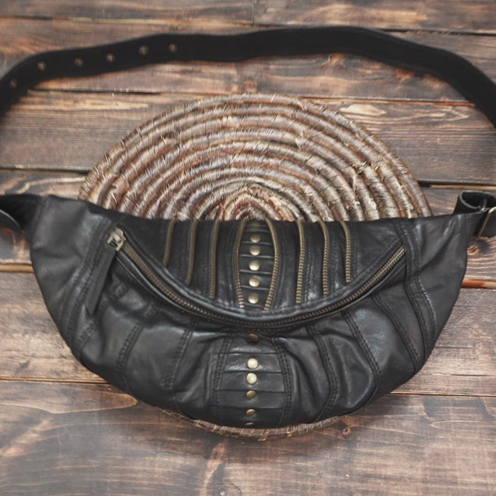 Steampunk-inspired leather fanny pack with multi-zip pockets and bold style.