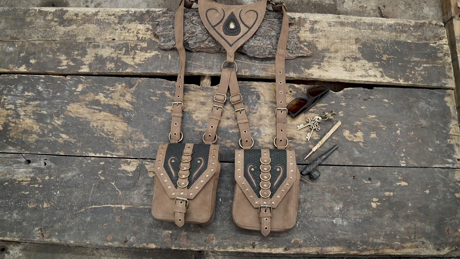 leather holster harness with embossed pattern and antique hardware