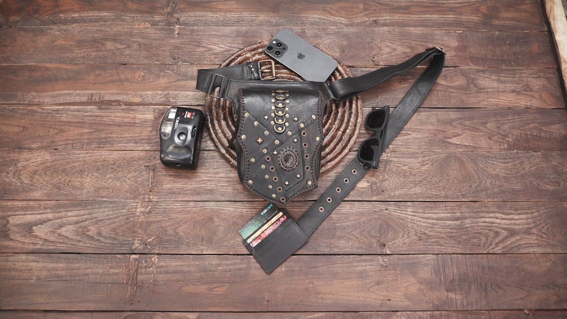 Leather waist belt featuring decorative studs and front storage pouch