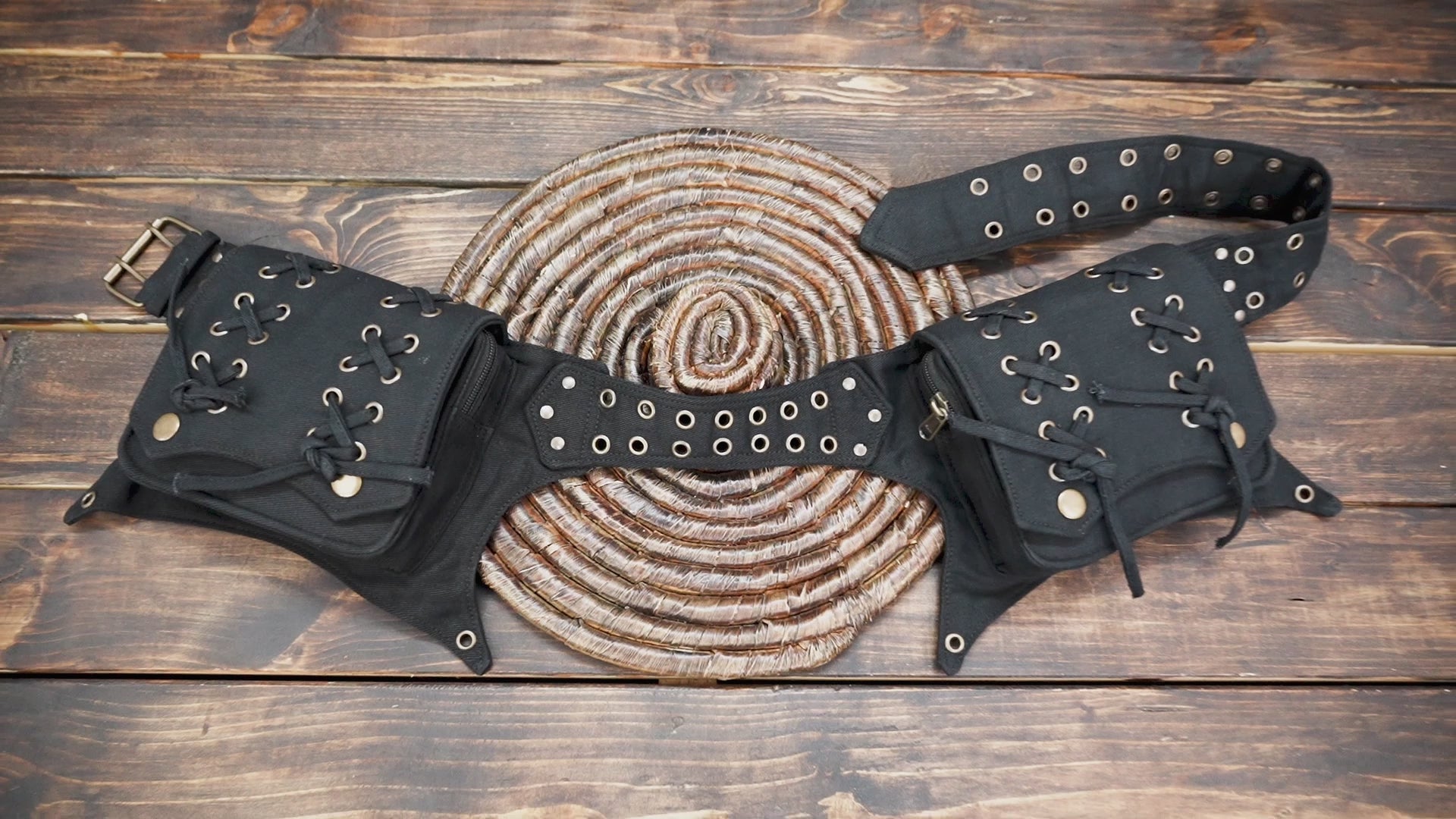 Gothic-style cotton waist bag with lace-up pockets on a wooden background.